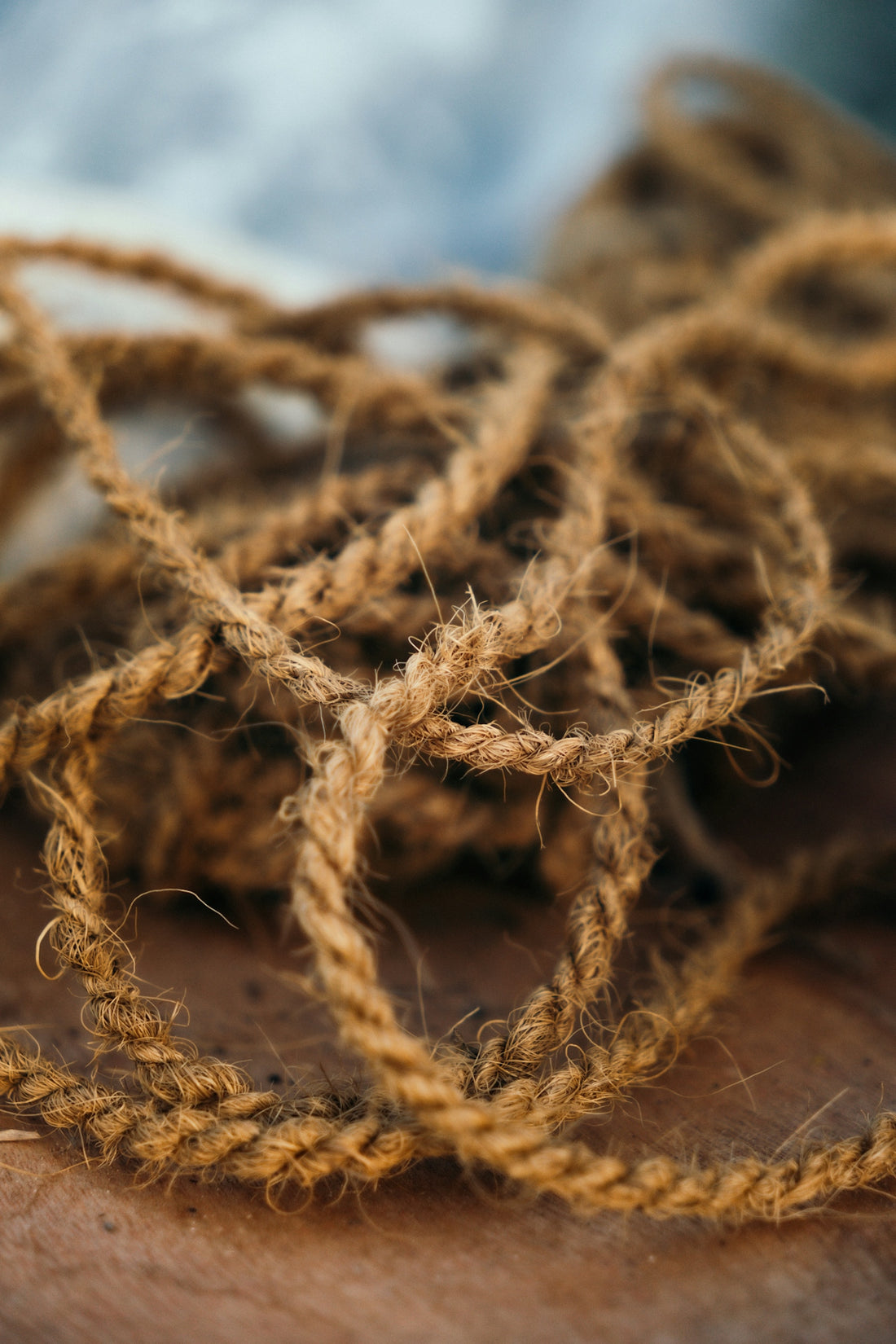 A close up of a person's hand holding a piece of yarn
