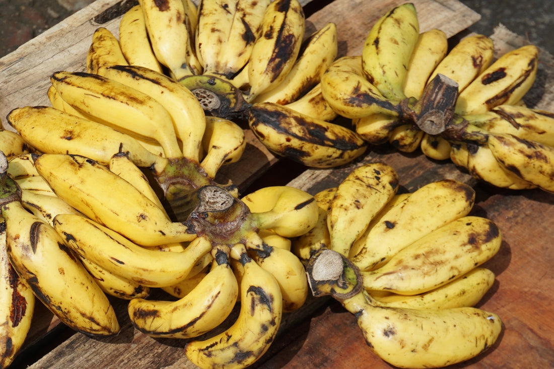 Clusters of yellow bananas are displayed together.
