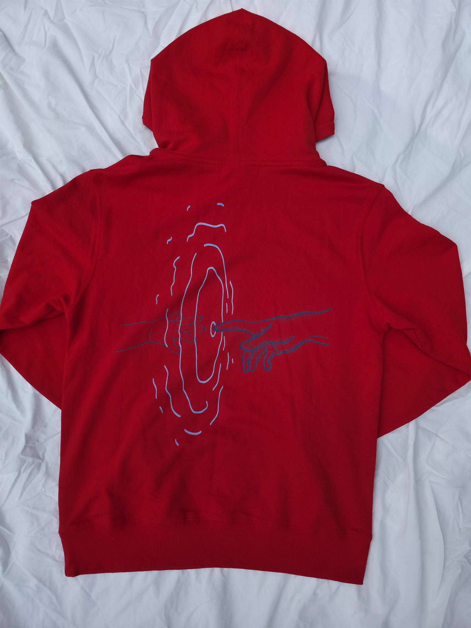 Red 100% cotton hoodie featuring minimalist hand and ripple linework design symbolizing legacy from Infinite Co’s ECHOES collection, crafted from sustainable natural fibers for modern streetwear.