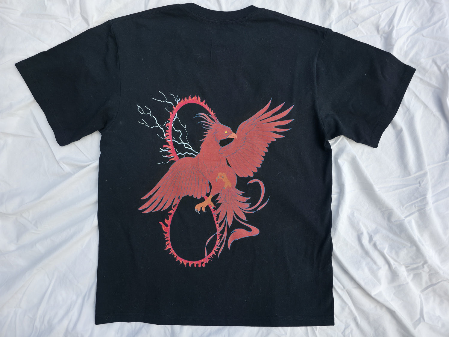 Black 100% cotton t-shirt featuring a bold red phoenix and infinity loop design symbolizing indomitability from Infinite Co’s RISE Collection, sustainable natural fiber streetwear.