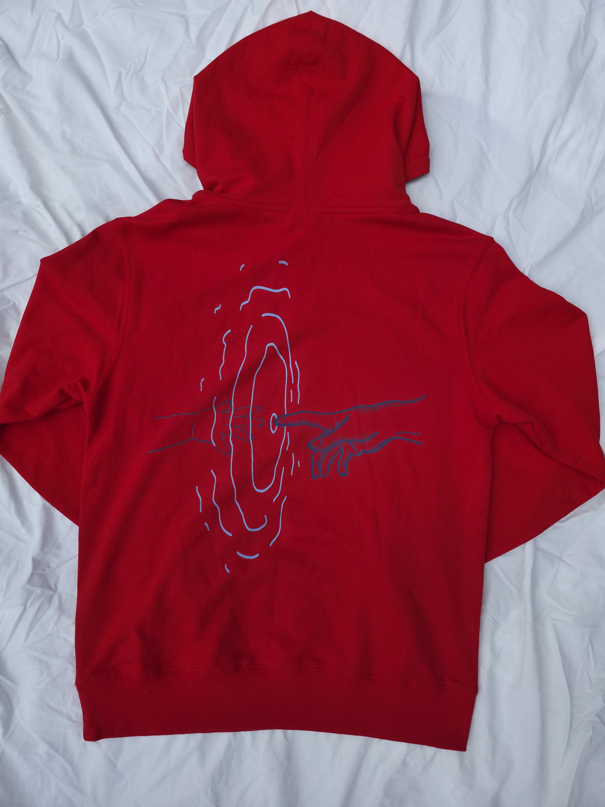 Red 100% cotton hoodie featuring minimalist hand and ripple linework design symbolizing legacy from Infinite Co’s ECHOES collection, crafted from sustainable natural fibers for modern streetwear.