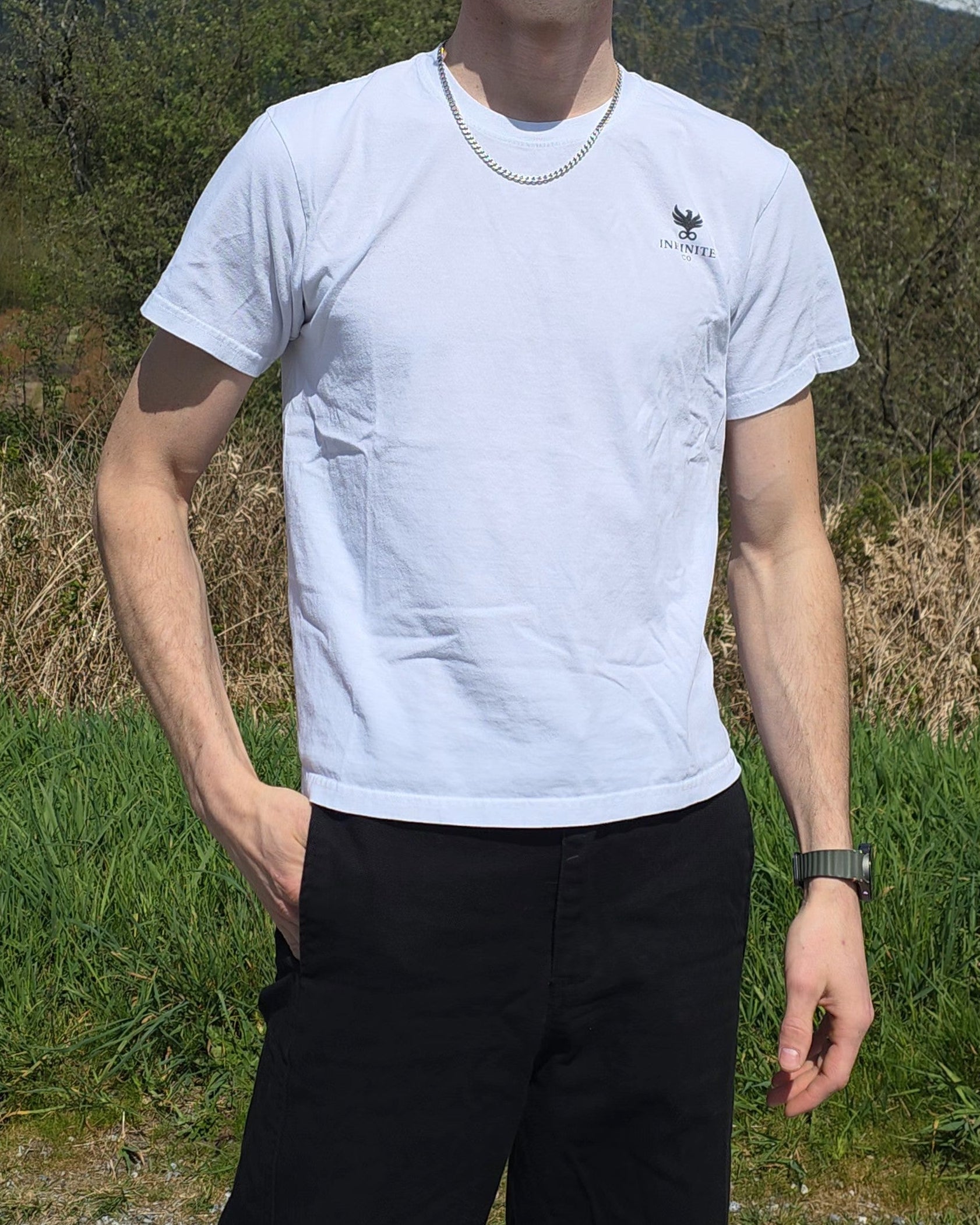 Man wearing sunglasses and a ECHOES Basic Tee with an Infinite Co logo