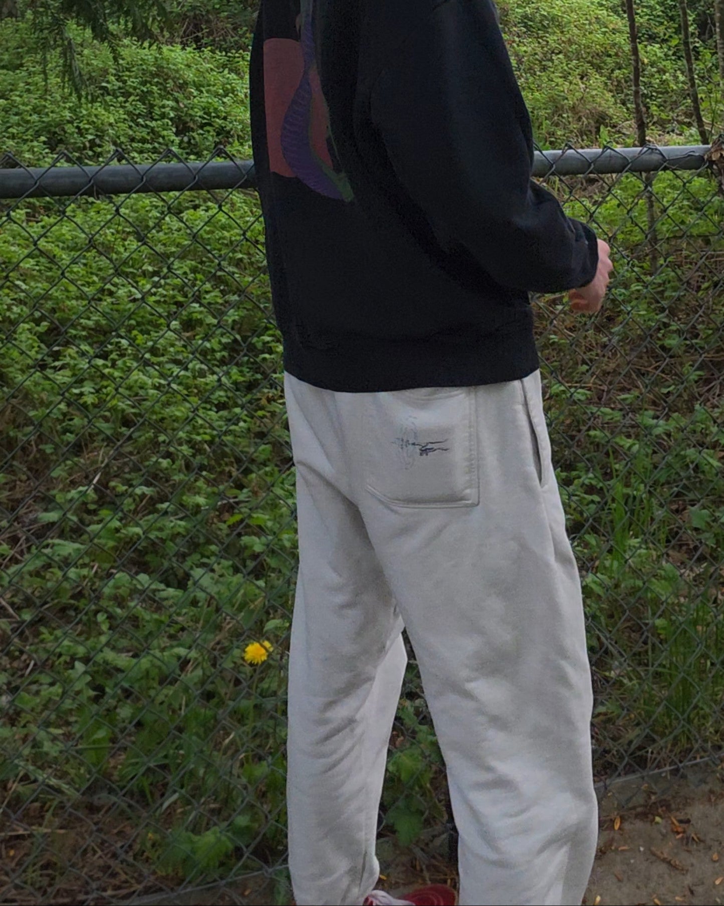 Person standing outdoors wearing ECHOES Cloud Comfort Pants in a natural setting with trees and greenery.