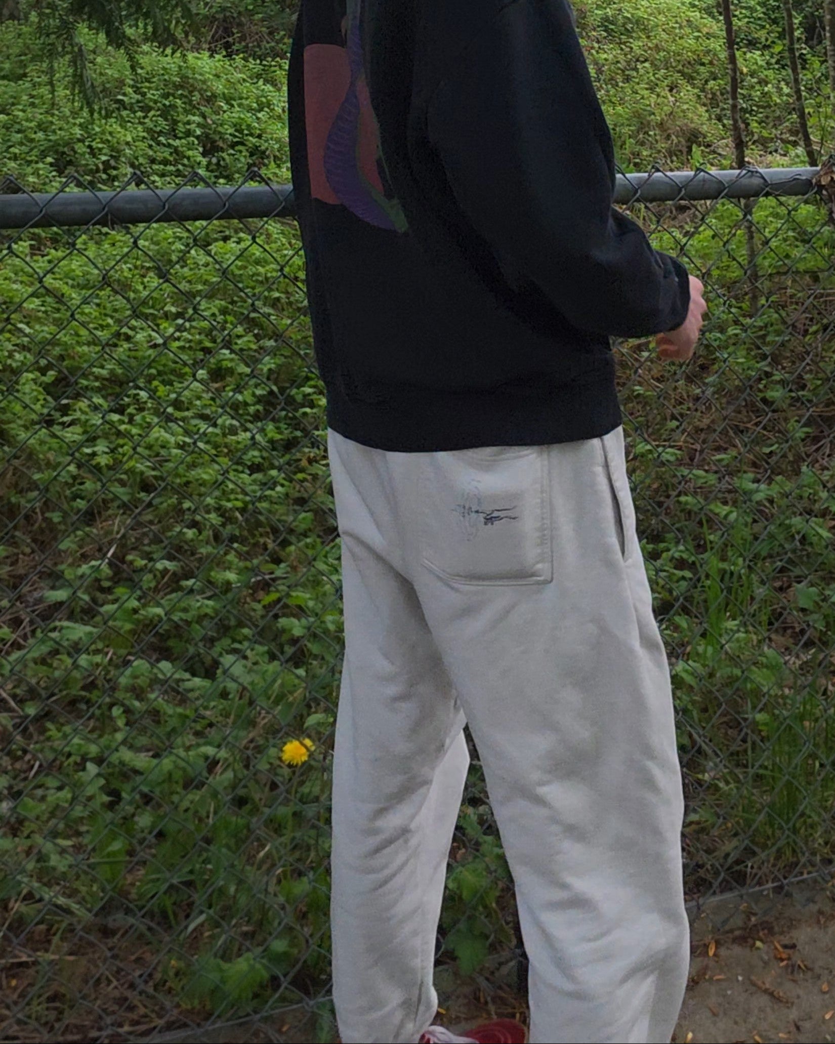 Person standing outdoors wearing ECHOES Cloud Comfort Pants in a natural setting with trees and greenery.